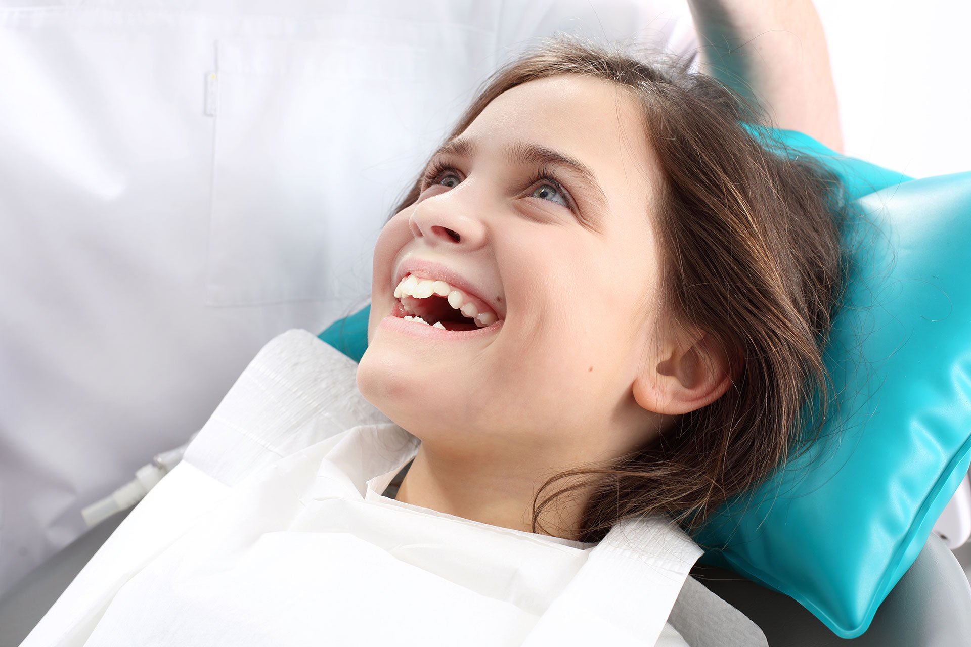 young girl smiling in dental chair