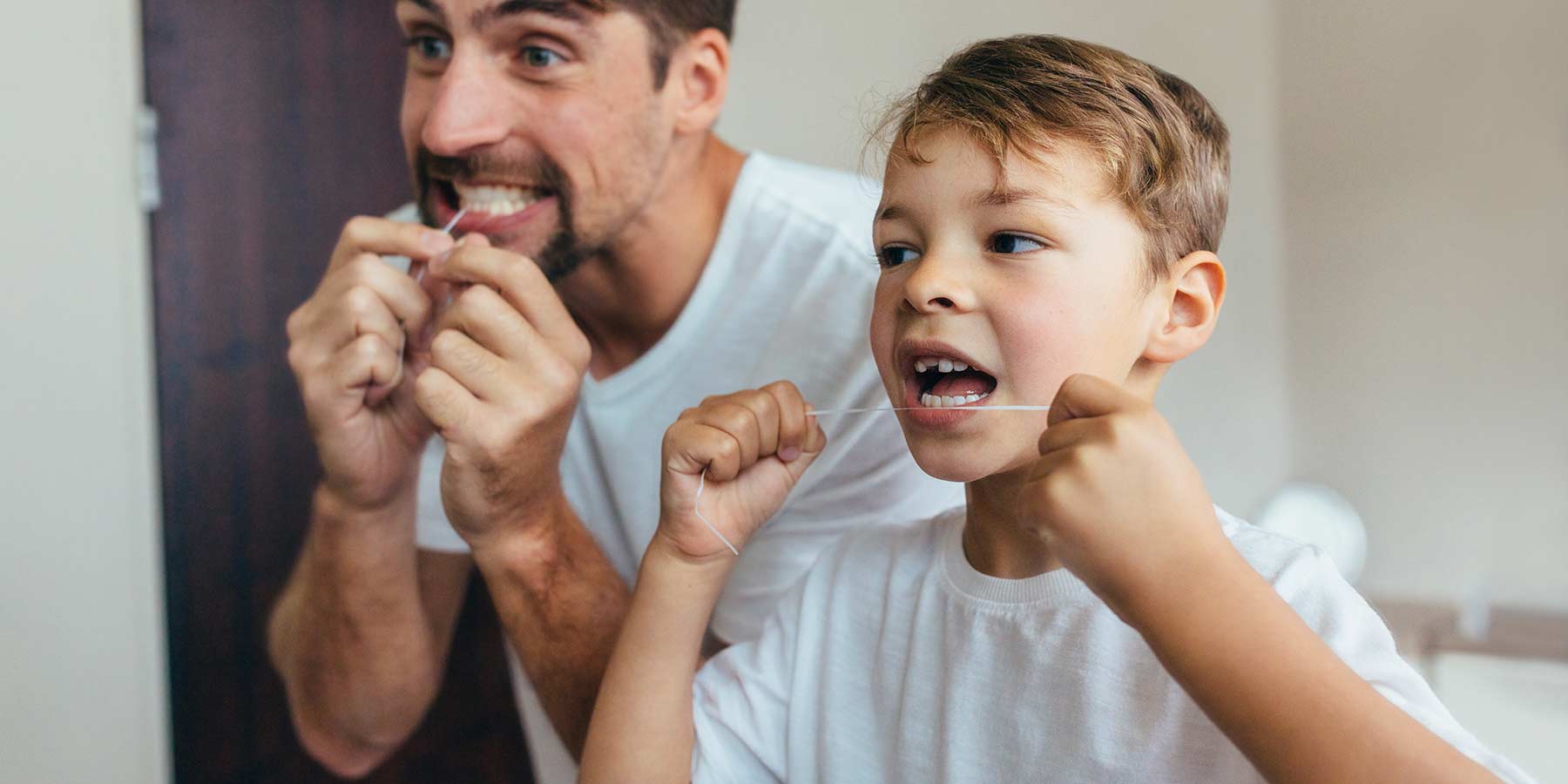 Child Flossing Teeth