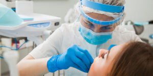 Dentist wearing PPE with a Patient